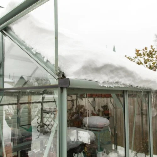 A Rhino greenhouse covered in winter snow