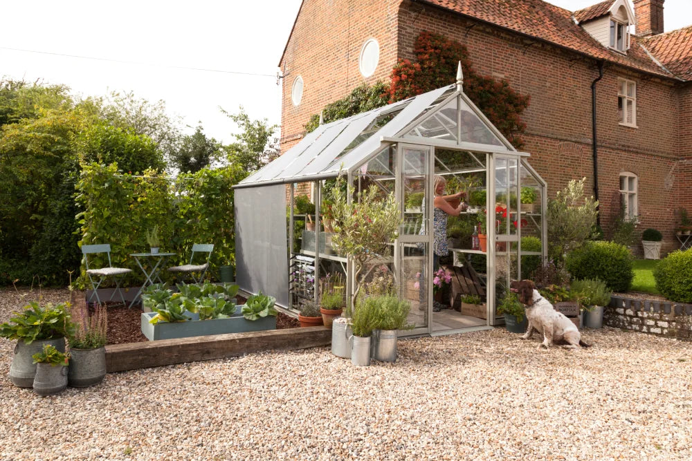 Rhino Ultimate 9x10 greenhouse in Silver Sage with a central path and staging both sides